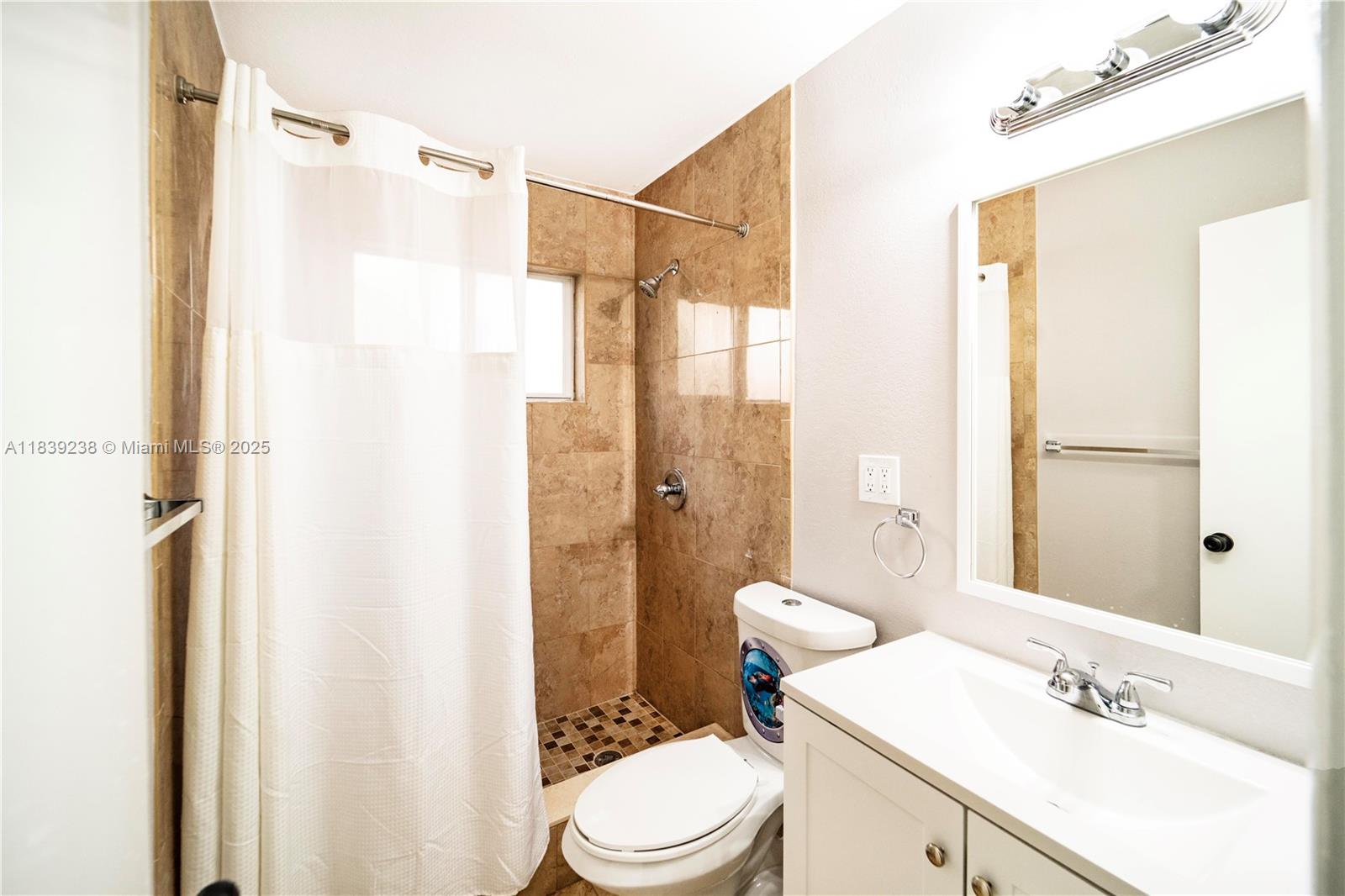 6990 Southwest 28th Street Miramar, FL 33023 - Photo 22 of 33 a bathroom with a sink mirror vanity and toilet