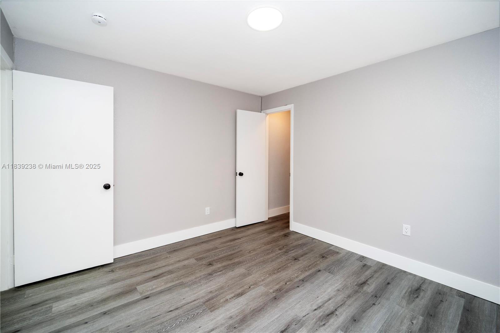 6990 Southwest 28th Street Miramar, FL 33023 - Photo 25 of 33 a view of an empty room with wooden floor