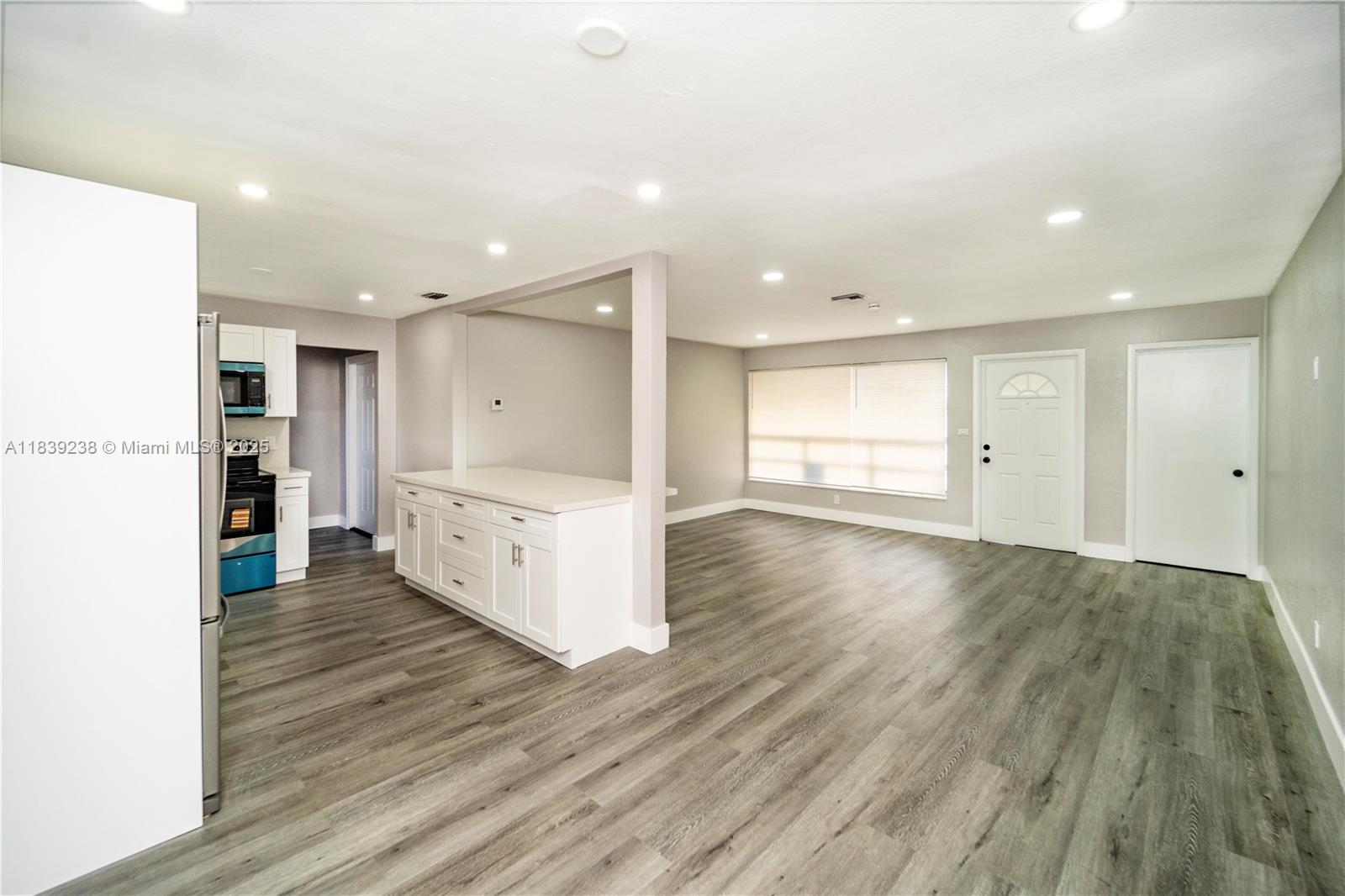 6990 Southwest 28th Street Miramar, FL 33023 - Photo 30 of 33 a large space with a large window and wooden floor
