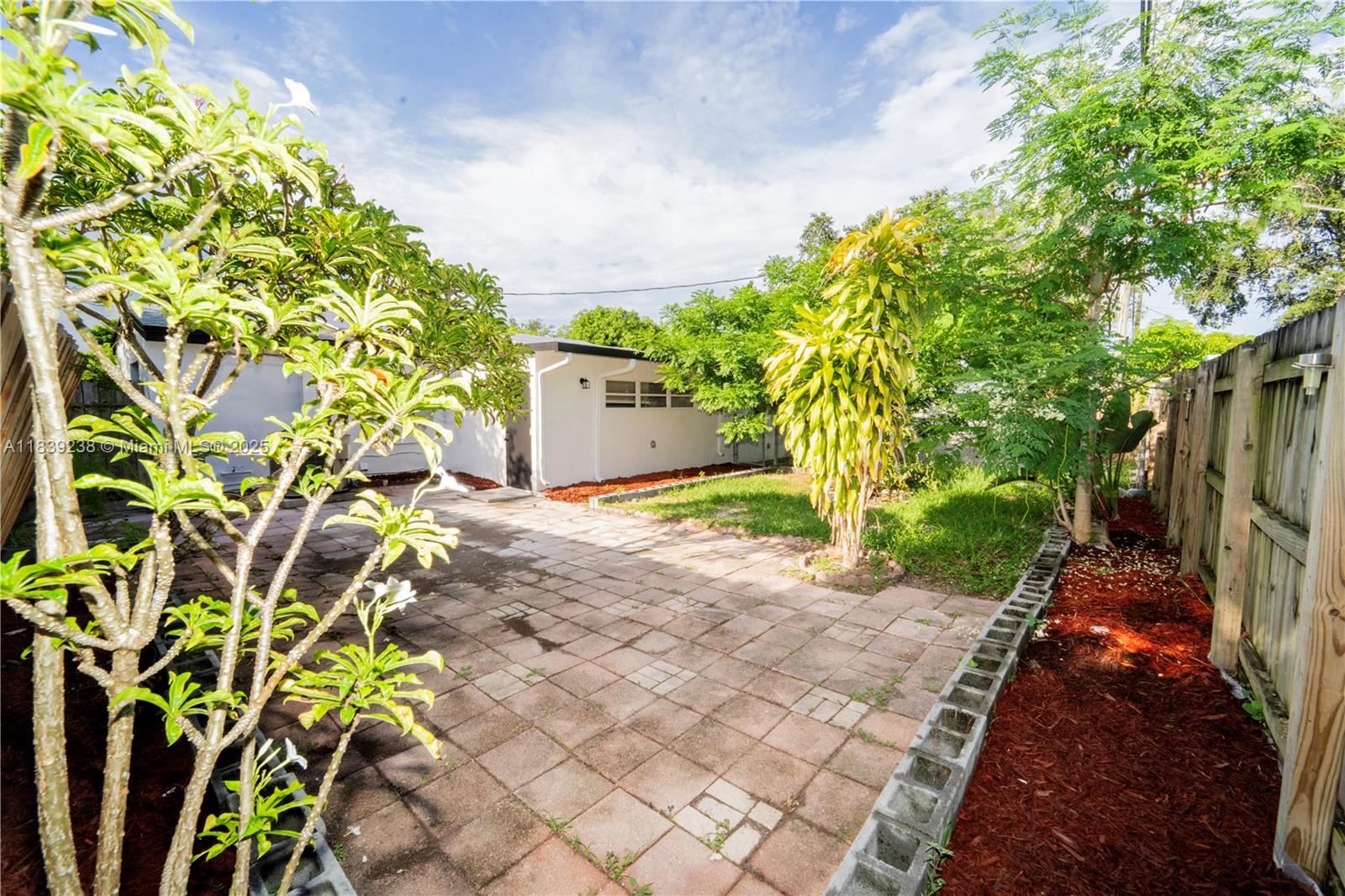 6990 Southwest 28th Street Miramar, FL 33023 - Photo 33 of 33 a view of a pathway with plants and large trees