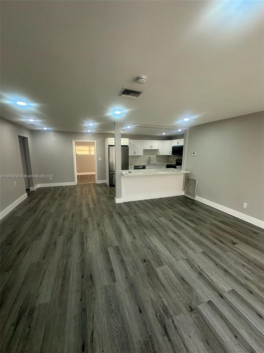 6990 Southwest 28th Street Miramar, FL 33023 - Photo 5 of 33 a view of a room with wooden floor