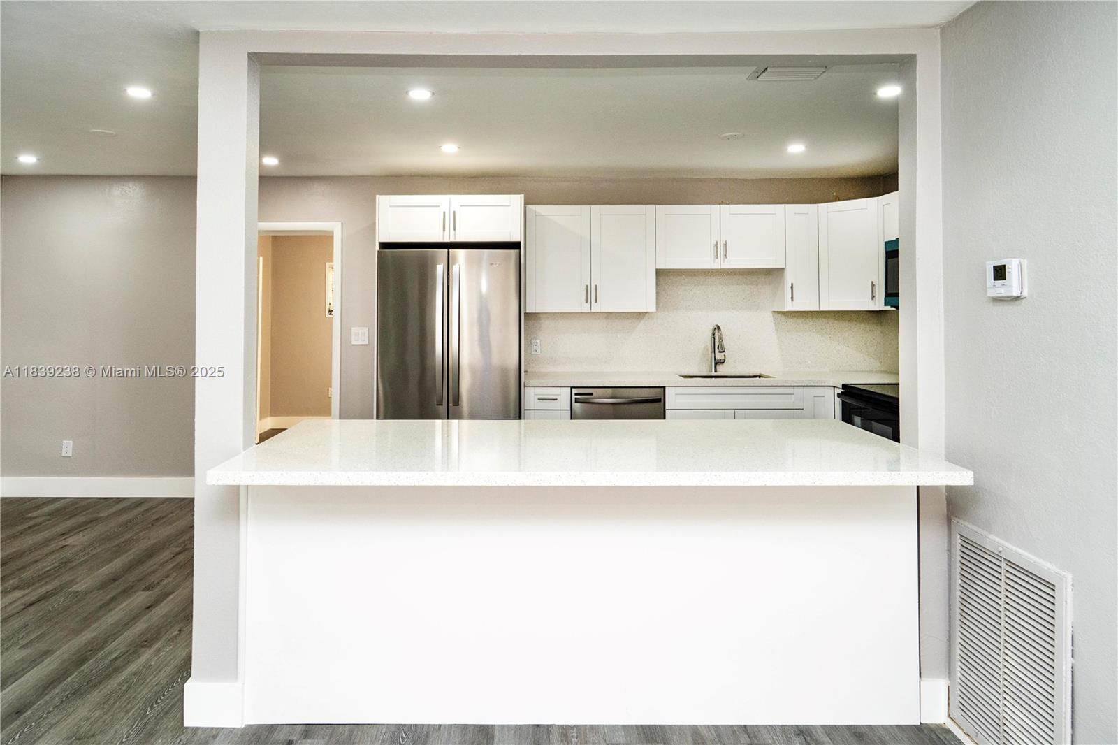 6990 Southwest 28th Street Miramar, FL 33023 - Photo 6 of 33 a kitchen with stainless steel appliances a refrigerator sink and cabinets
