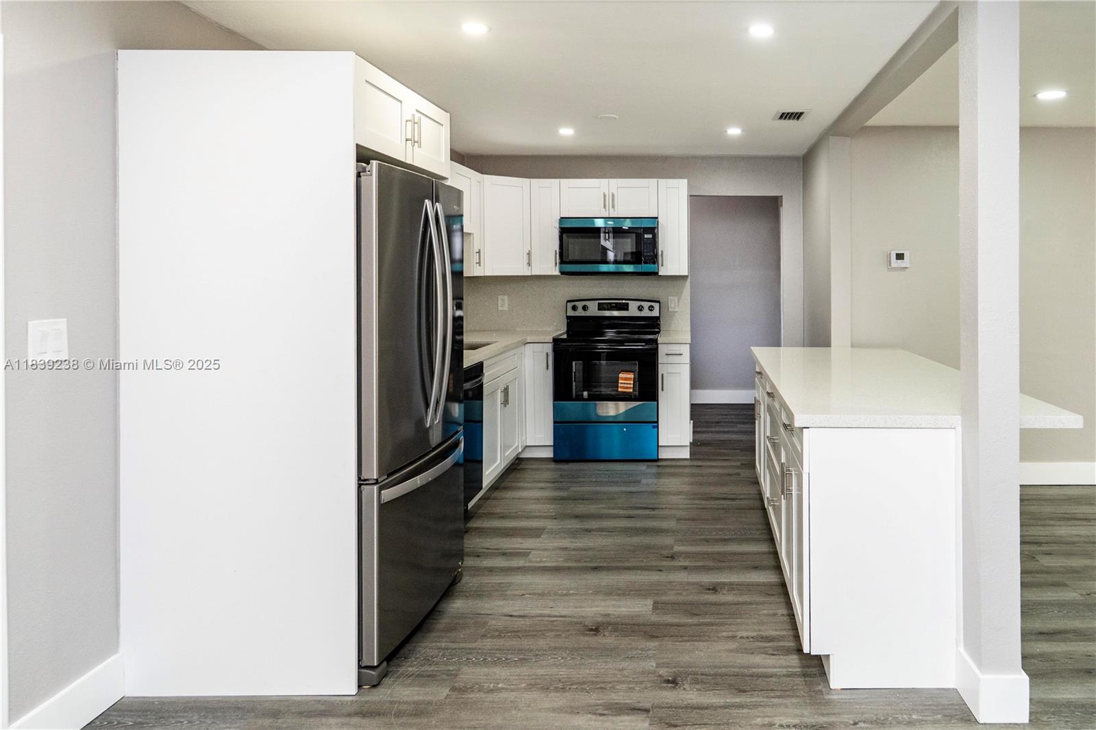 6990 Southwest 28th Street Miramar, FL 33023 - Photo 7 of 33 a kitchen with stainless steel appliances a refrigerator and a stove