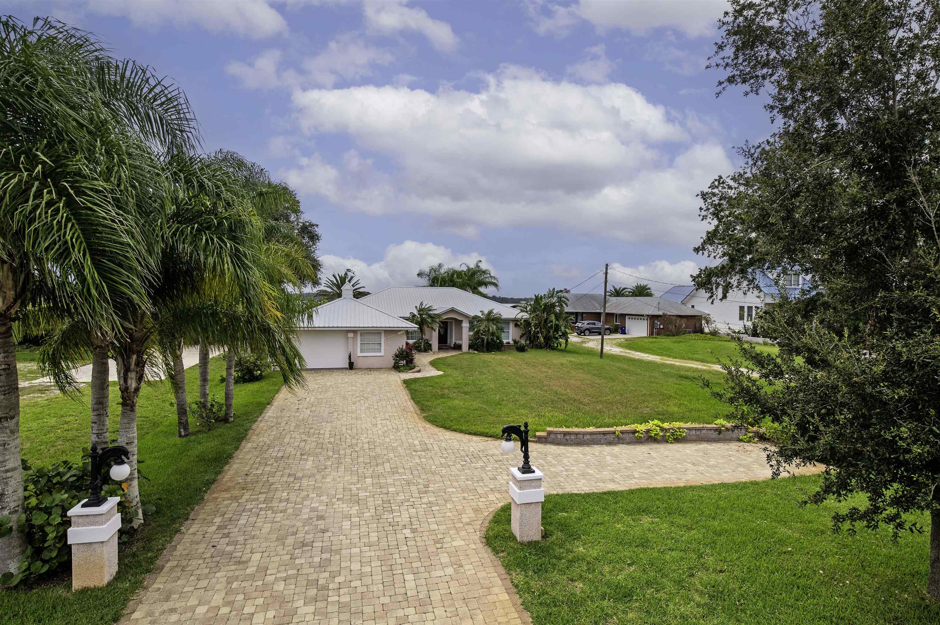 6331 Salado Road St. Augustine, FL 32080 - Photo 54 of 60 a view of a swimming pool with a yard and palm trees