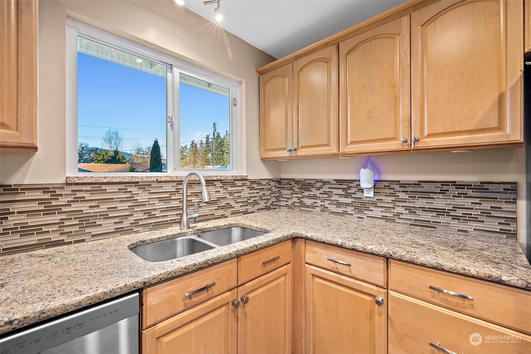 14610 Southeast 113th Street Renton, WA 98059 - Photo 11 of 34 a kitchen with granite countertop a sink and a white cabinets