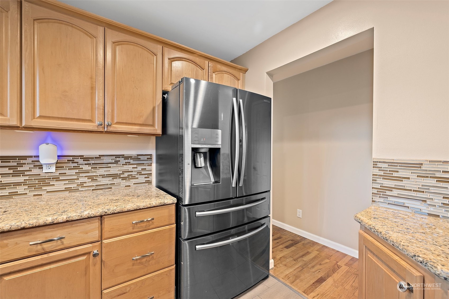 14610 Southeast 113th Street Renton, WA 98059 - Photo 13 of 34 a kitchen with granite countertop stainless steel appliances and wooden cabinets
