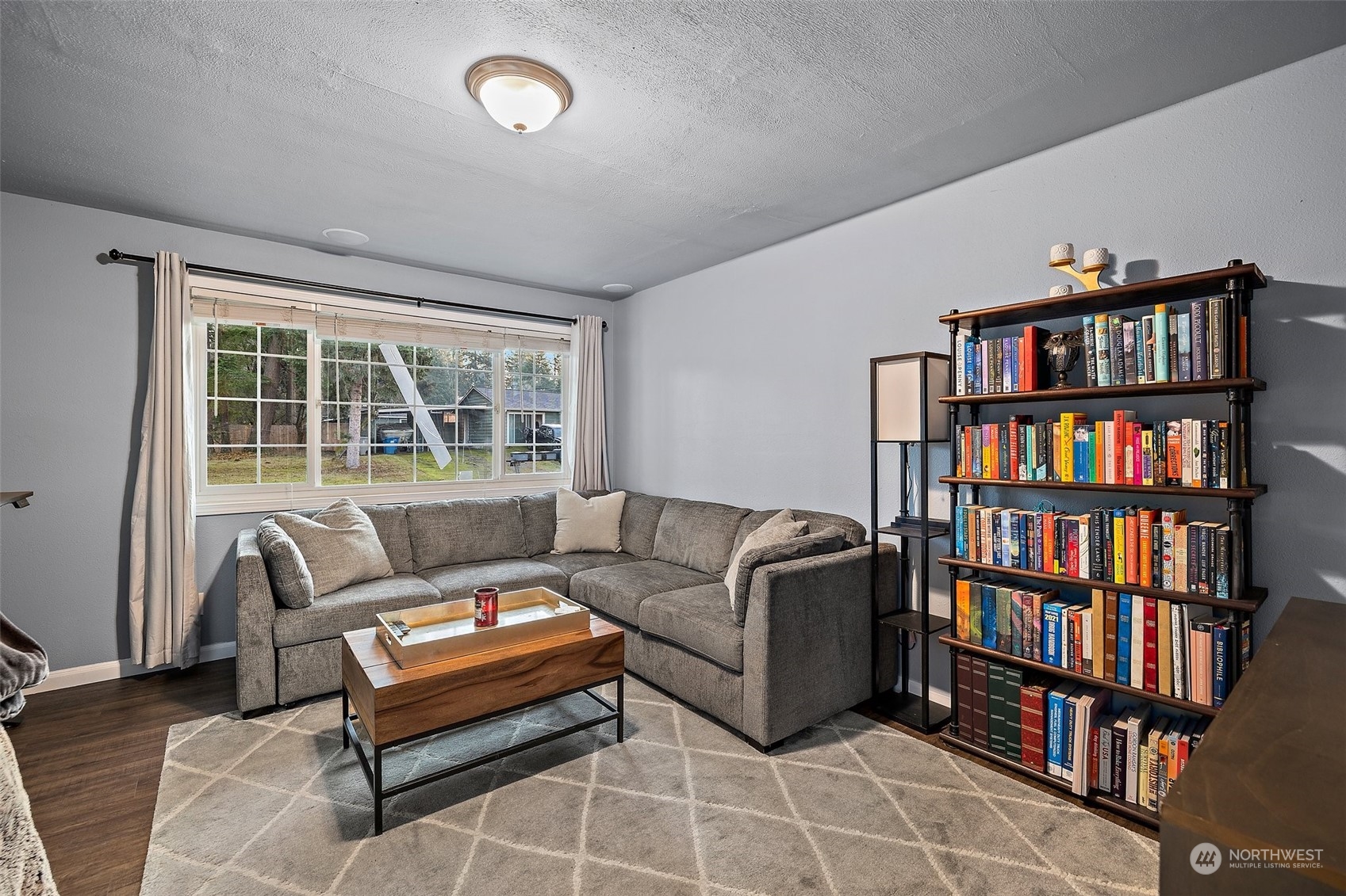14610 Southeast 113th Street Renton, WA 98059 - Photo 24 of 34 a living room with furniture a book shelf and a book shelf