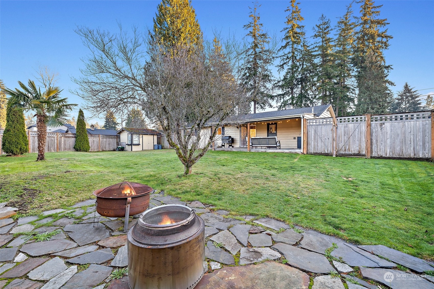14610 Southeast 113th Street Renton, WA 98059 - Photo 29 of 34 a view of a backyard with table and chairs and a fire pit
