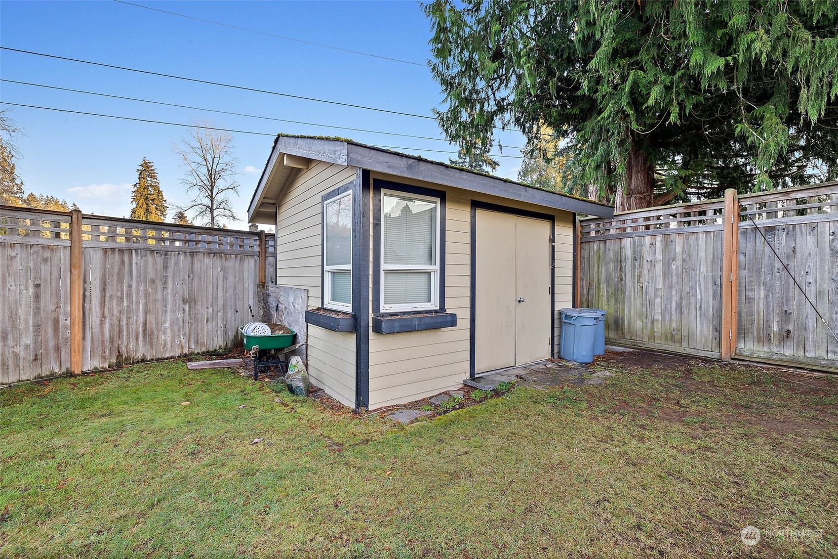 14610 Southeast 113th Street Renton, WA 98059 - Photo 32 of 34 a backyard of a house with lawn chairs and wooden fence