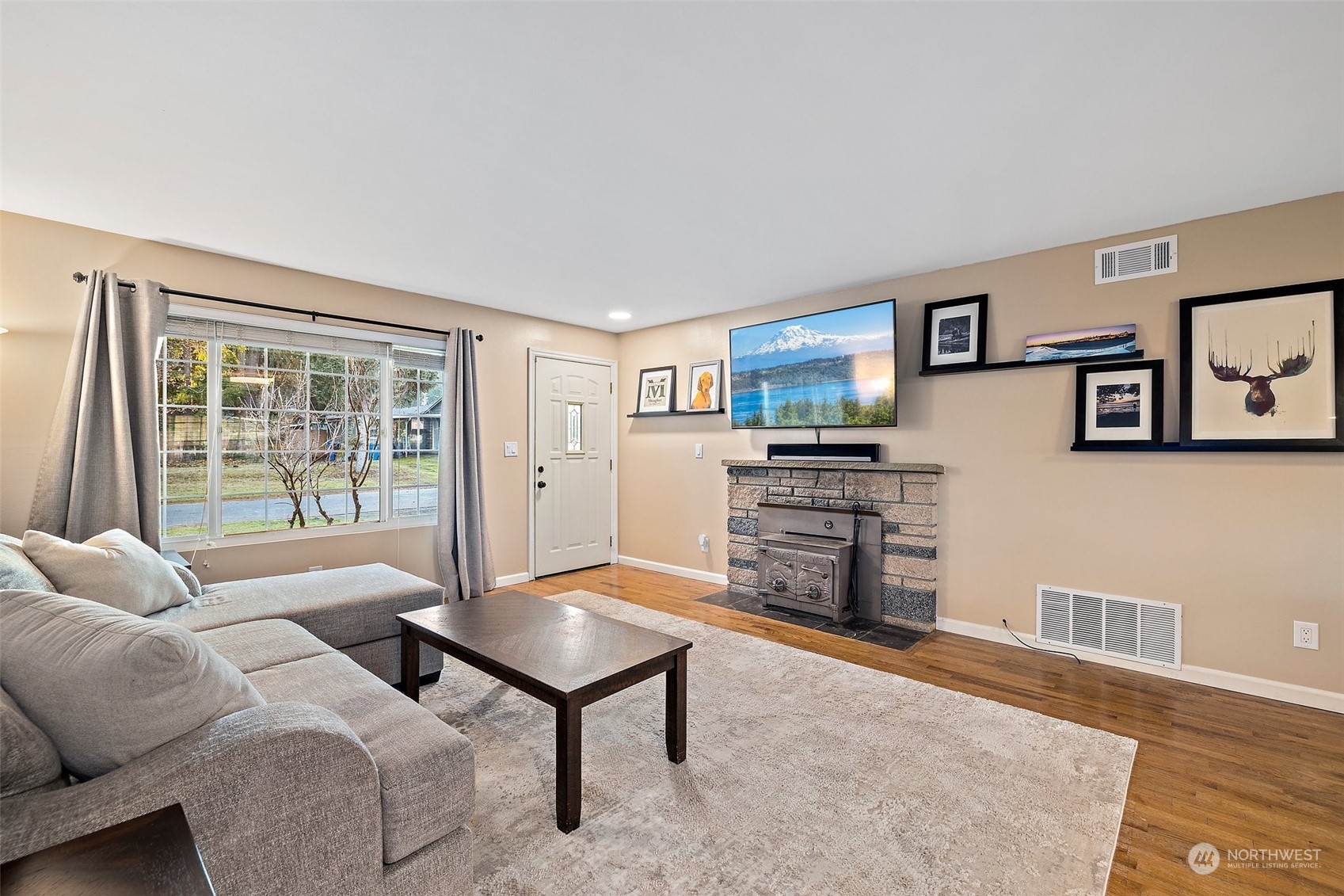 14610 Southeast 113th Street Renton, WA 98059 - Photo 7 of 34 a living room with furniture and a flat screen tv