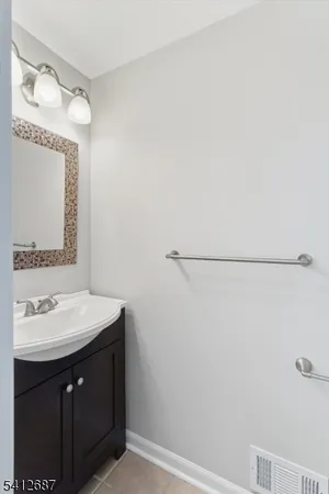 a bathroom with a sink vanity and a mirror