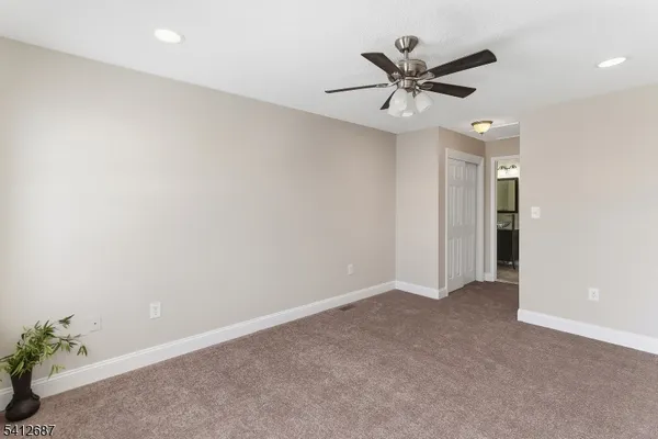 an empty room with a ceiling fan and a ceiling fan
