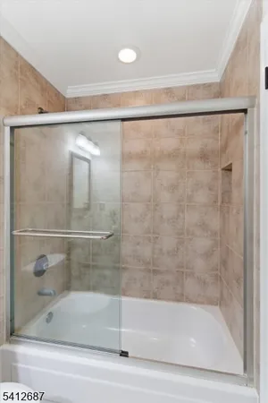 a bathroom with a shower and a bath tub