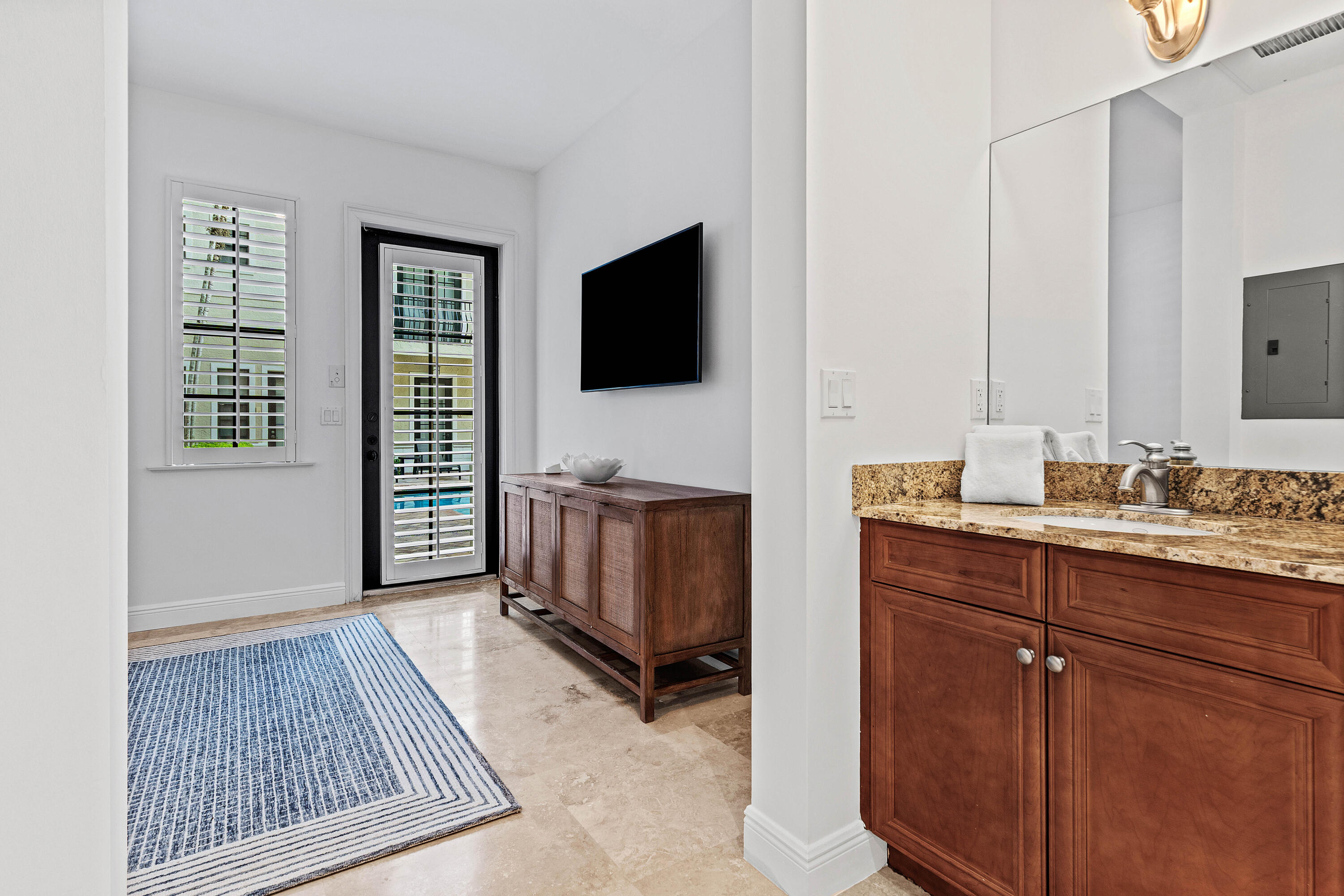 110 Gleason Street, Unit 203 Delray Beach, FL 33483 - Photo 11 of 25 a living room with furniture and a flat screen tv