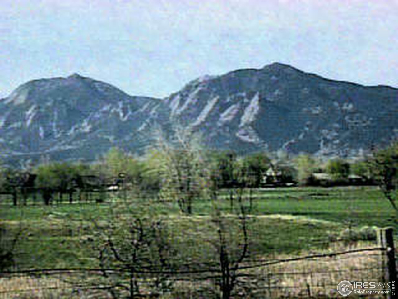 4062 Pleasant Ridge Road Boulder, CO 80301 - Photo 4 of 6 a view of a lush green hillside and a building