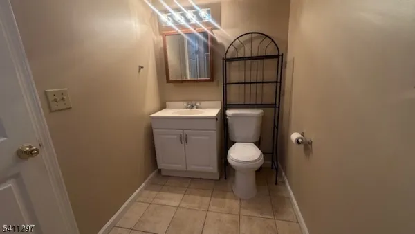 a bathroom with a toilet a sink and vanity