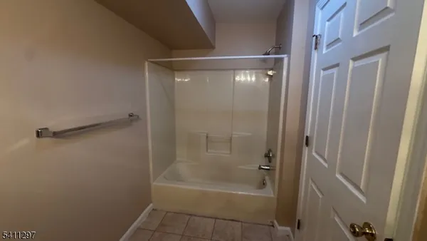 a bathroom with a glass shower door