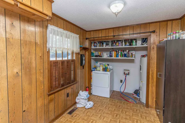 a view of a livingroom with furniture and staircase