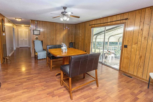 a dining room with furniture window and wooden floor