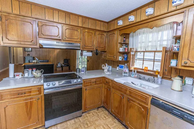 a kitchen with stainless steel appliances granite countertop a sink and cabinets