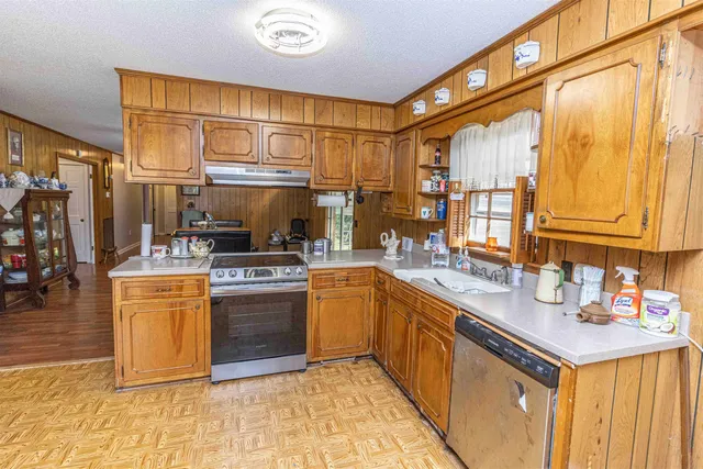 a kitchen with stainless steel appliances granite countertop a sink and cabinets