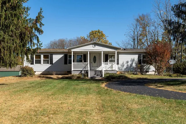 a view of a house with swimming pool and sitting area