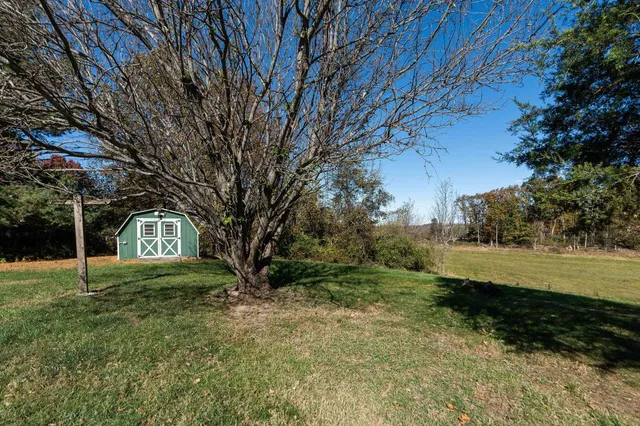 an empty room with fireplace and windows