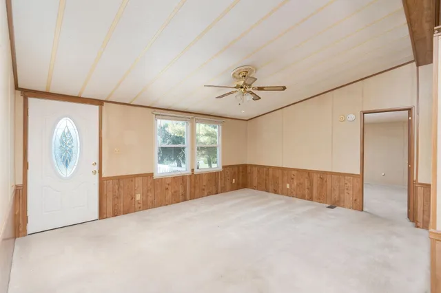 a view of a workspace with furniture and a chandelier