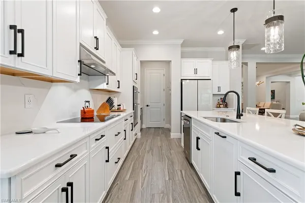 a kitchen with stainless steel appliances a sink stove and cabinets