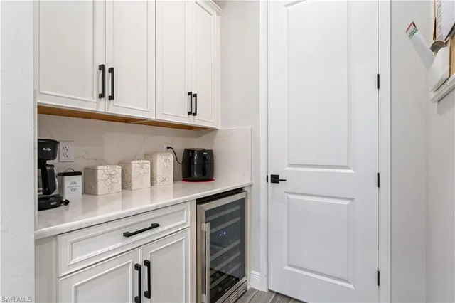 a kitchen with white cabinets and white appliances