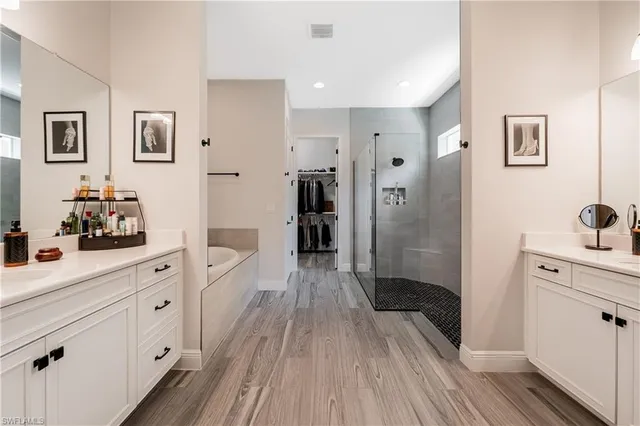 a large kitchen with a lot of counter space and wooden floor