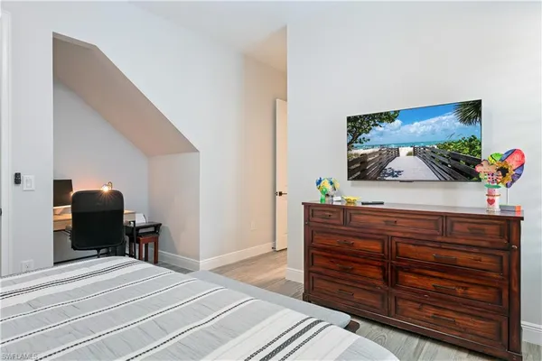 a bedroom with a bed and a dresser
