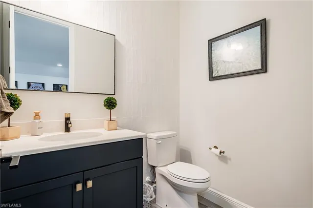 a bathroom with a toilet a sink and mirror