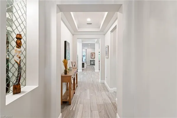 a view of hallway with wooden floor