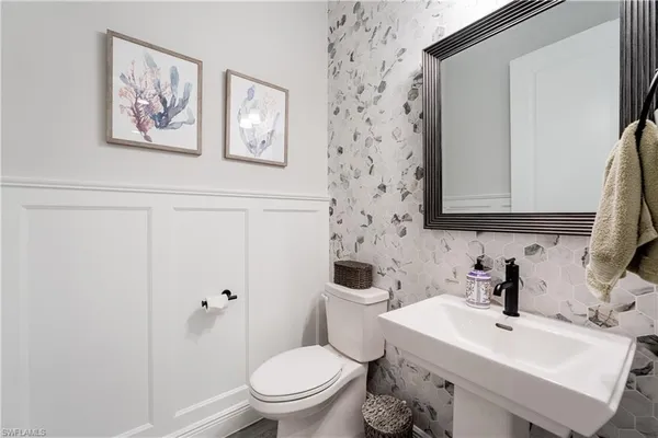 a white toilet sitting next to a bathroom sink