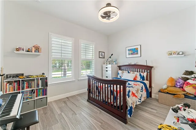 a bed room with a bed and a book shelf