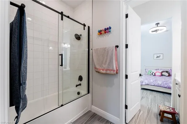 a bathroom with a tub shower and sink