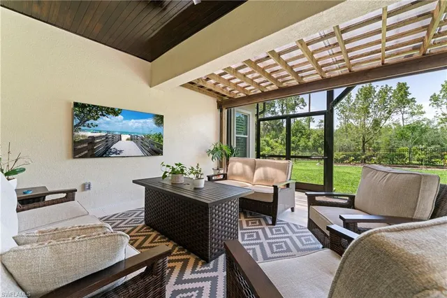 a living room with furniture and a floor to ceiling window