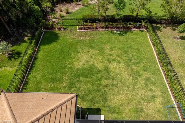a view of a backyard with swimming pool