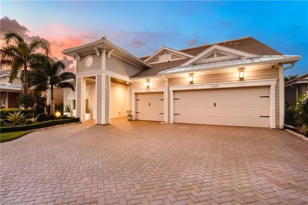 a view of a house with a yard and garage