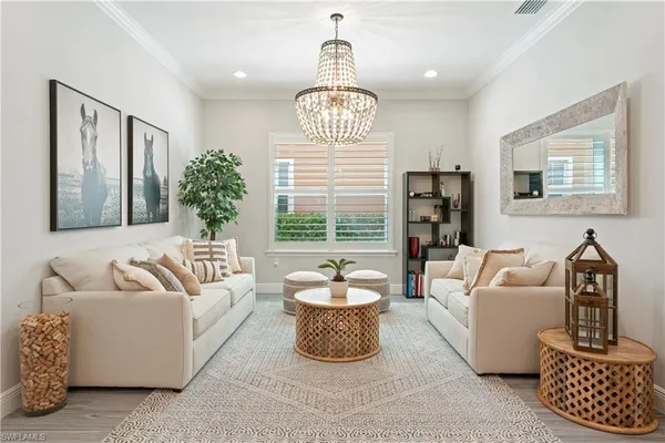 a living room with furniture a window and a chandelier