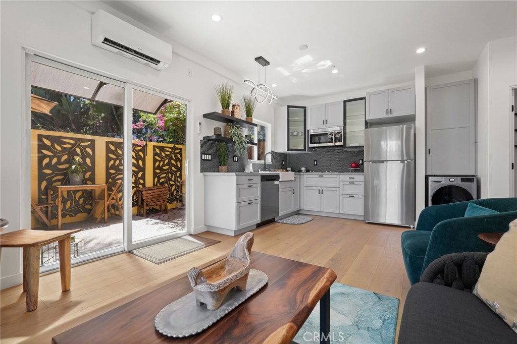 2258 Helios Drive Los Angeles, CA 90068 - Photo 2 of 27 a living room with stainless steel appliances furniture a rug and a kitchen view