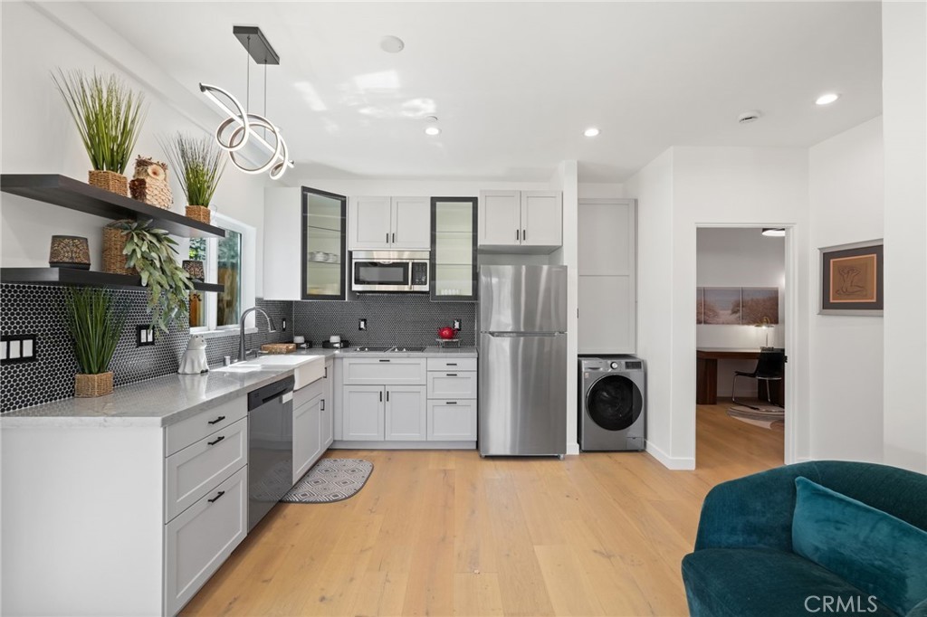 2258 Helios Drive Los Angeles, CA 90068 - Photo 3 of 27 a open kitchen with stainless steel appliances kitchen island a refrigerator sink and stove