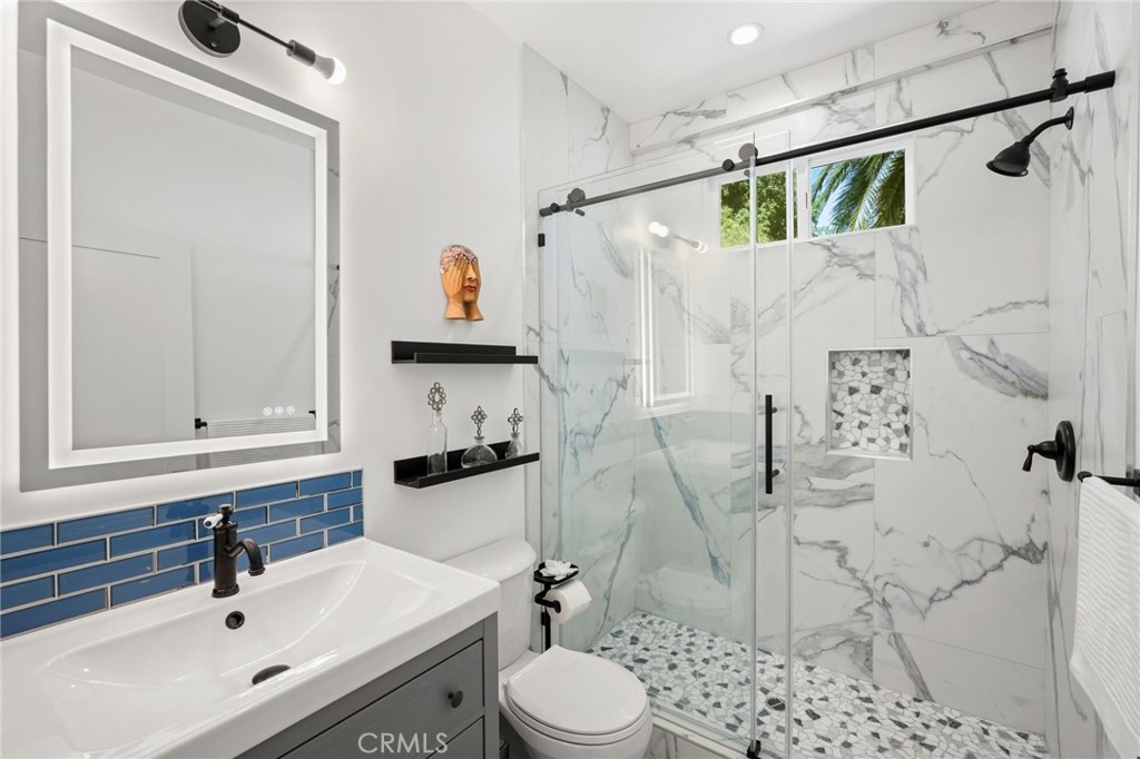 2258 Helios Drive Los Angeles, CA 90068 - Photo 9 of 27 a bathroom with a sink toilet and shower