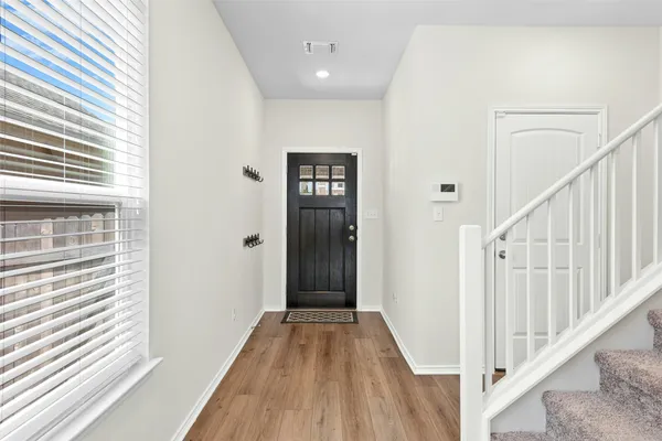 a dining room with furniture and wooden floor