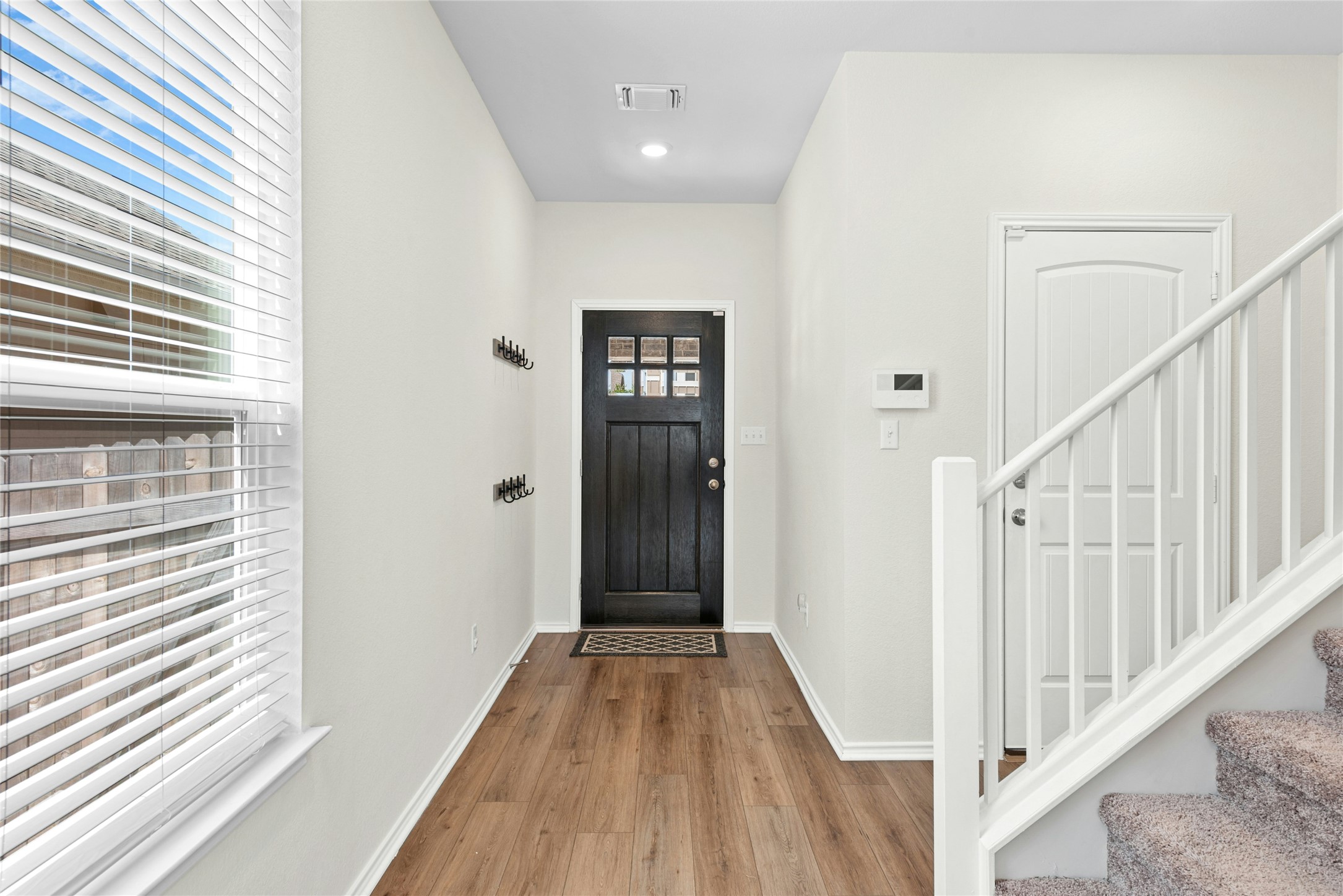 1124 Aronia Lane Georgetown, TX 78626 - Photo 12 of 31 a view of a hallway with wooden floor and staircase