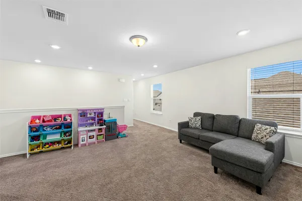 a view of a living room with wooden floor and staircase