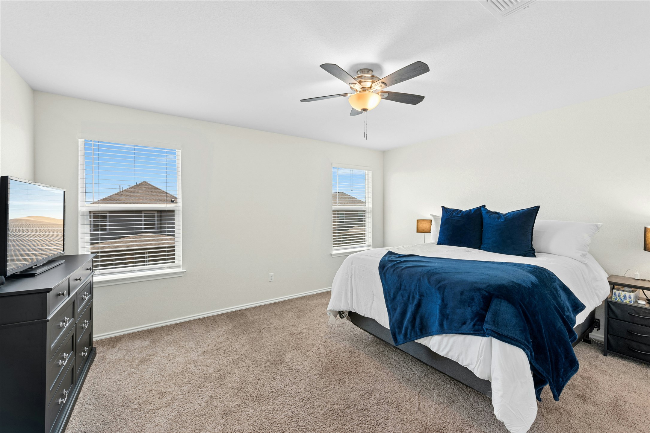 1124 Aronia Lane Georgetown, TX 78626 - Photo 16 of 31 a spacious bedroom with a bed and a flat screen tv
