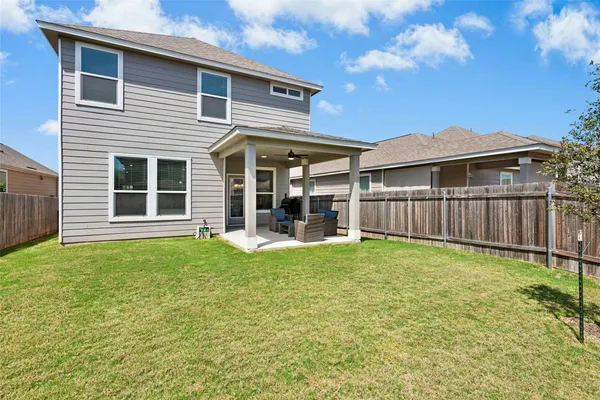 a view of a patio with couches chairs and a fire pit