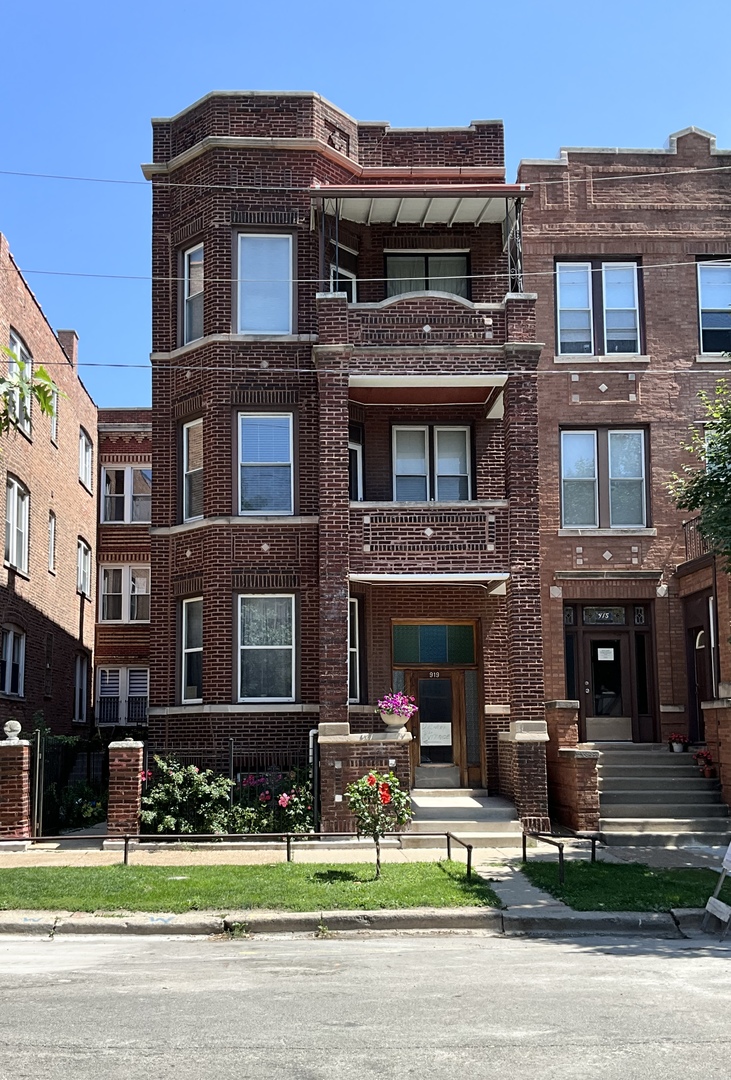 919 North Leavitt Street, Unit 2F Chicago, IL 60622 - Photo 1 of 18 a front view of a building with garden and trees